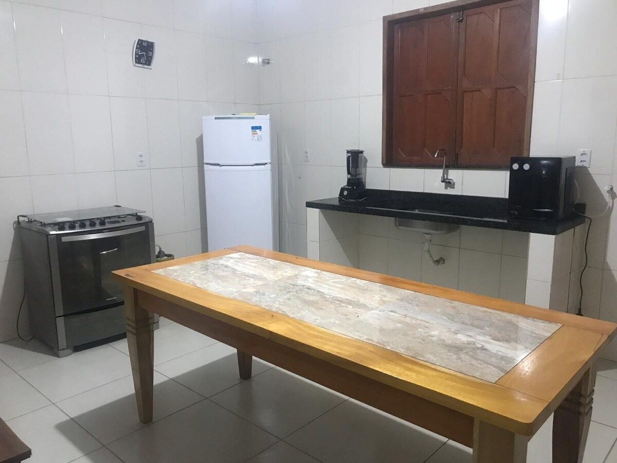 Kitchen with fridge, counter and stove