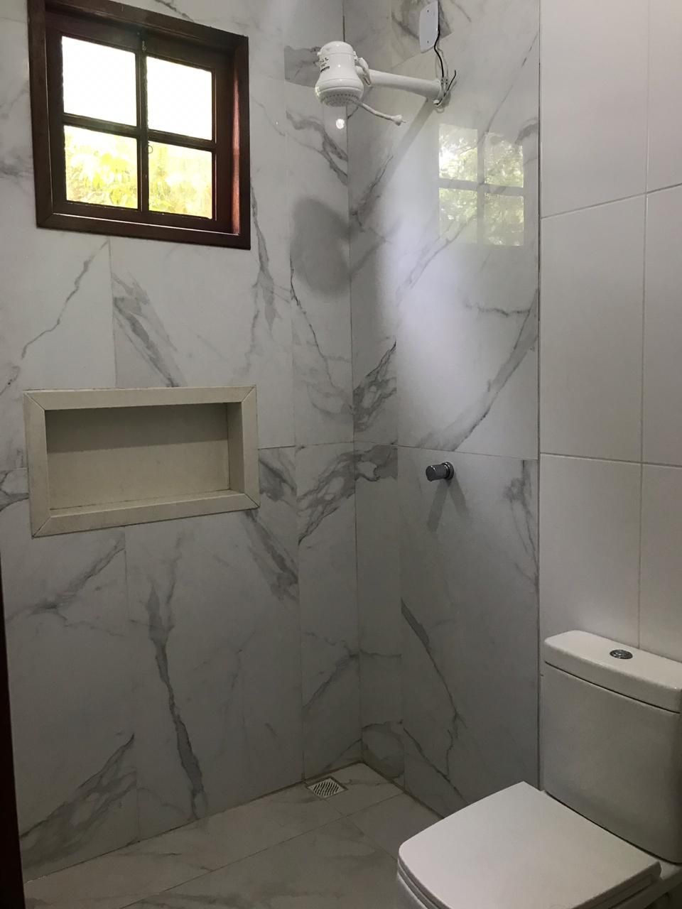 Bathroom with shower and marble-effect tiles