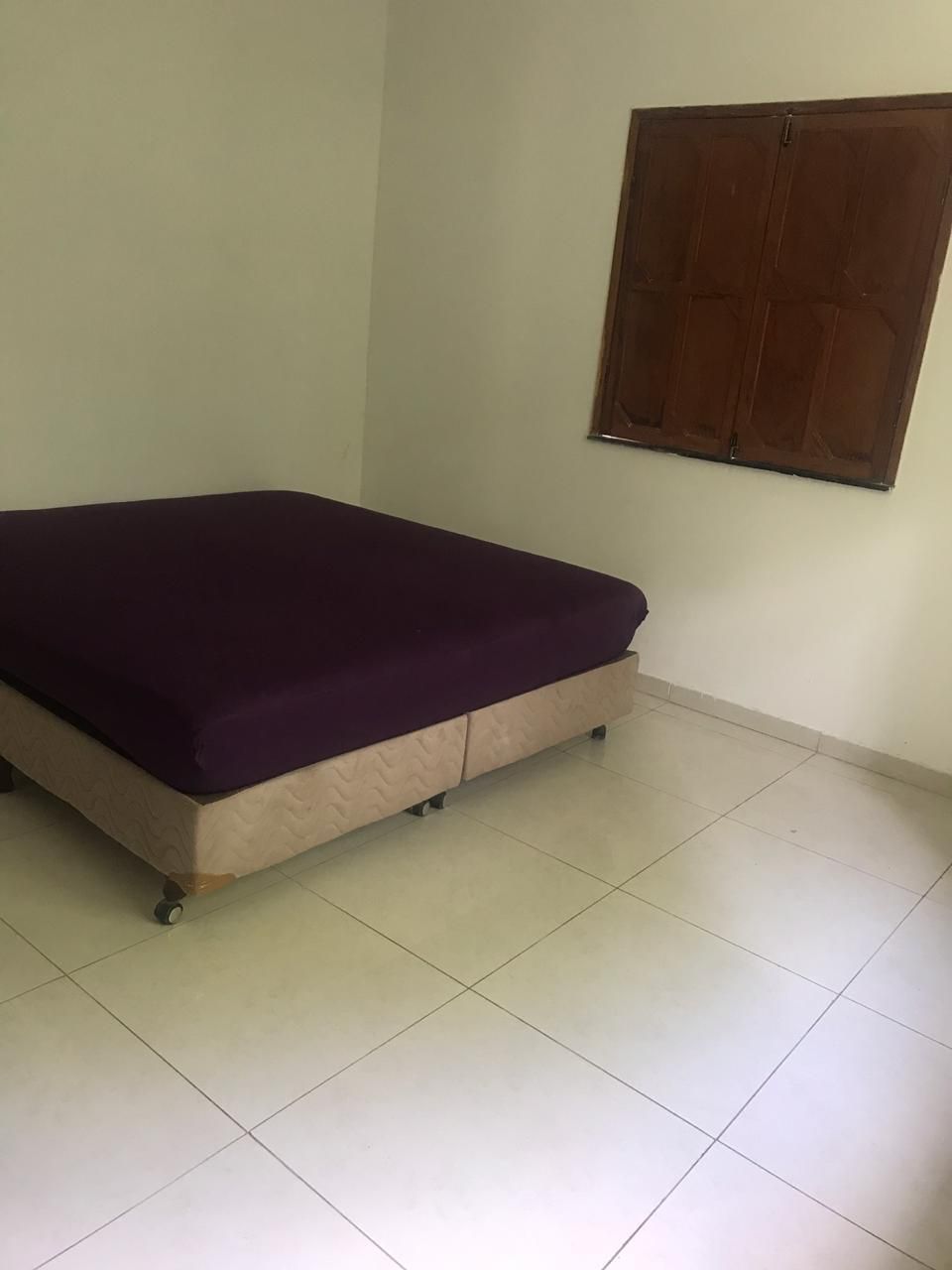 Bedroom with a double bed and wooden window