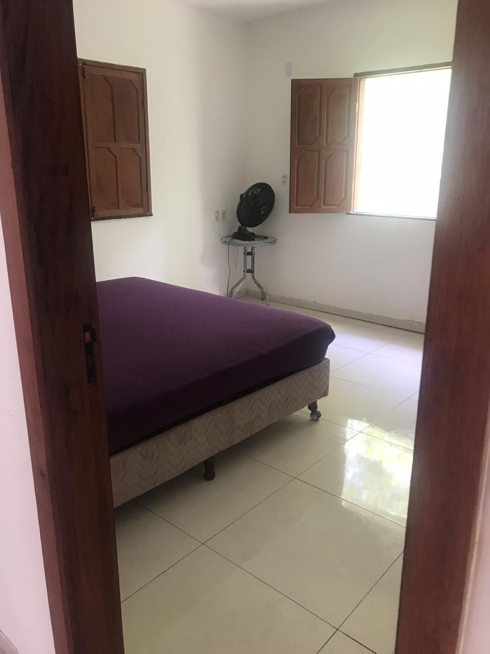 Bedroom with a double bed, fan and windows
